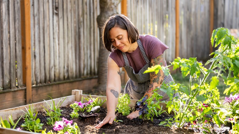woman in apron works on garden