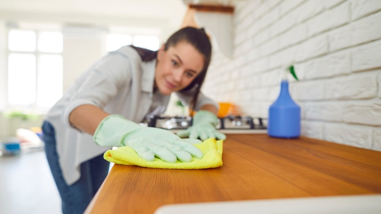 woman cleans kitchen counter