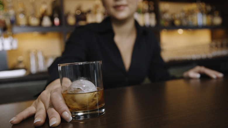 Someone reaching for bourbon