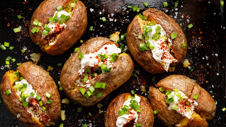 a tray of loaded baked potatoes