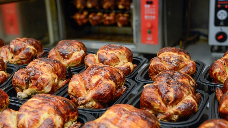 rotisserie chickens on display at a supermarket