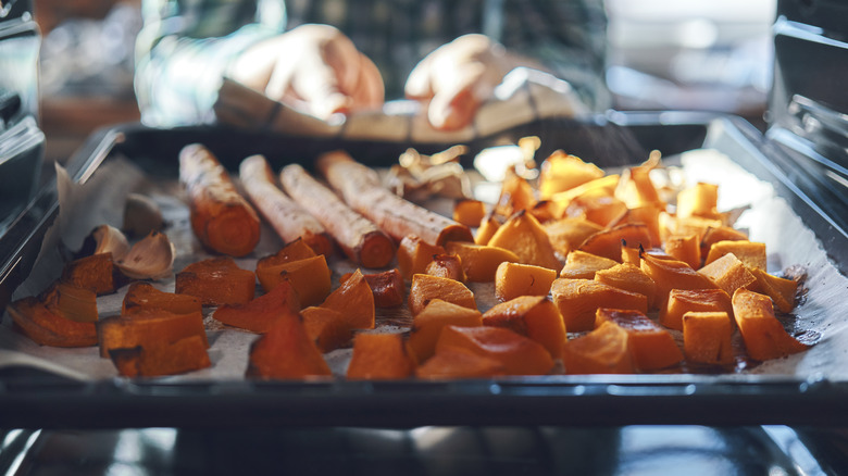 Squash and carrots roasted on parchment-lined baking sheet