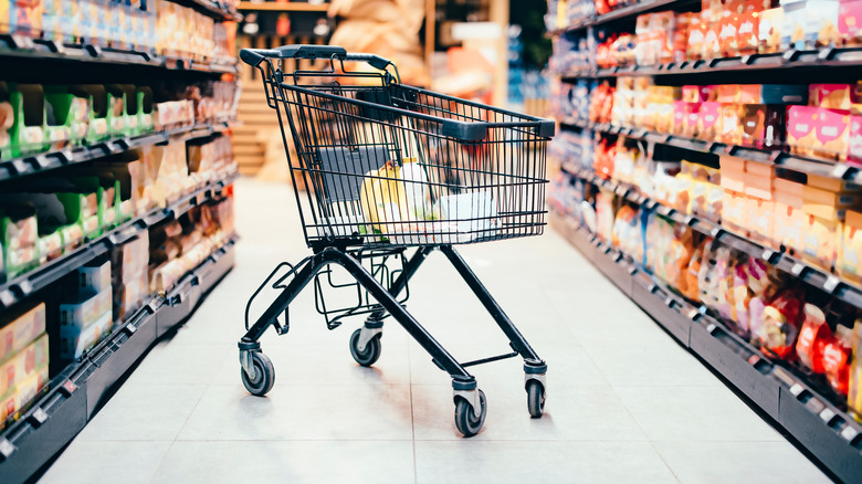 shopping cart parked in grocery store aisle