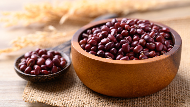 A wooden bowl and spoon of adziku beans