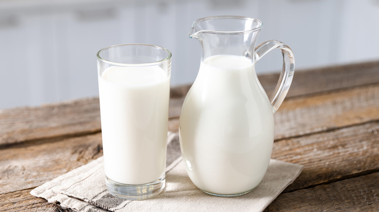 A glass and jug of milk
